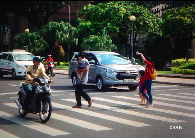 A family crosses a road in Ho Chi Minh City