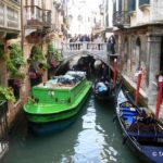 Garbage collection boat and gondolas in Venice